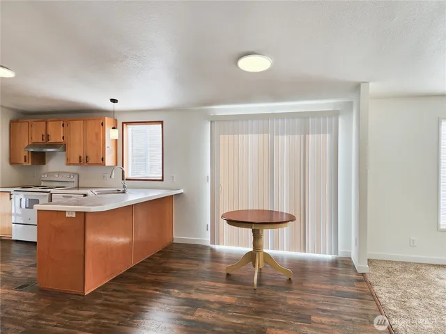 a kitchen with stainless steel appliances granite countertop a stove a sink dishwasher and a refrigerator