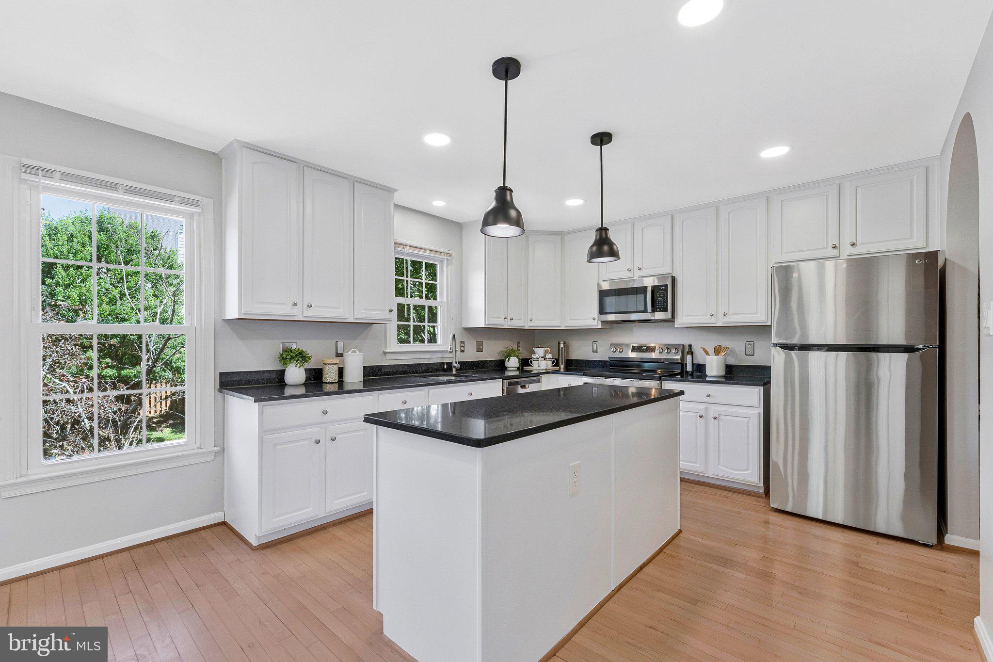 2000 Gallows Tree Lane Vienna, VA 22182 - Photo 18 of 58 a kitchen with white cabinets and appliances