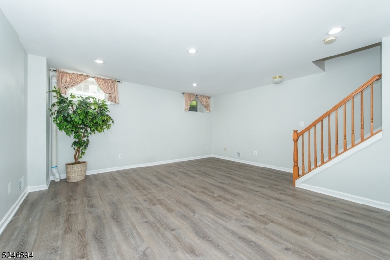 551 Coventry Drive Nutley, NJ 07110 - Photo 12 of 22 wooden floor in an empty room with a window