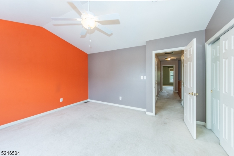 551 Coventry Drive Nutley, NJ 07110 - Photo 14 of 22 an empty room with closet and a chandelier fan