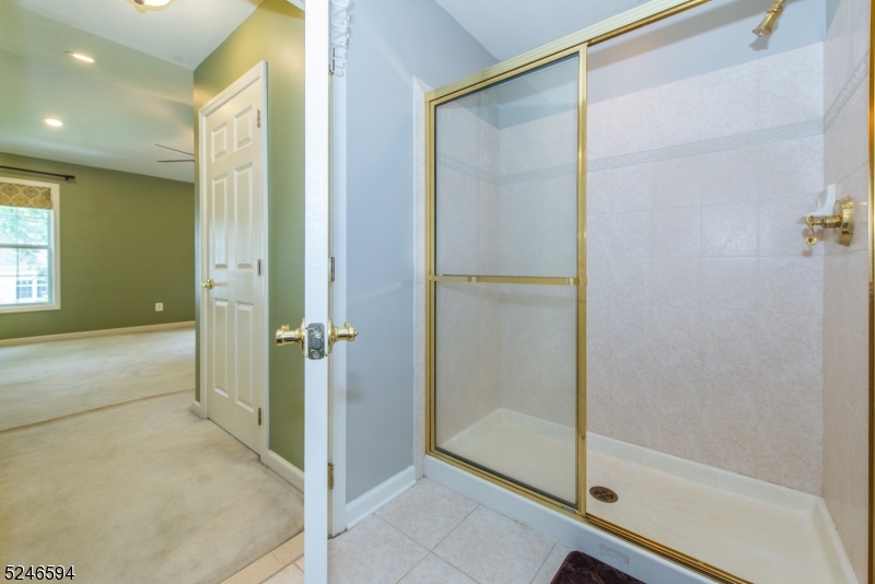 551 Coventry Drive Nutley, NJ 07110 - Photo 16 of 22 a bathroom with a glass shower door