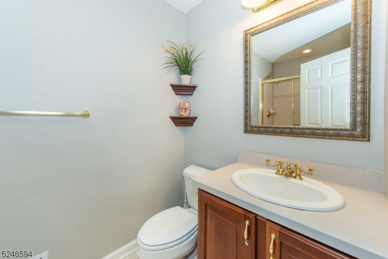 551 Coventry Drive Nutley, NJ 07110 - Photo 20 of 22 a bathroom with a toilet sink and mirror