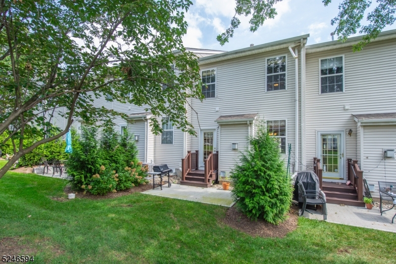 551 Coventry Drive Nutley, NJ 07110 - Photo 3 of 22 a view of a chair and table in backyard of the house