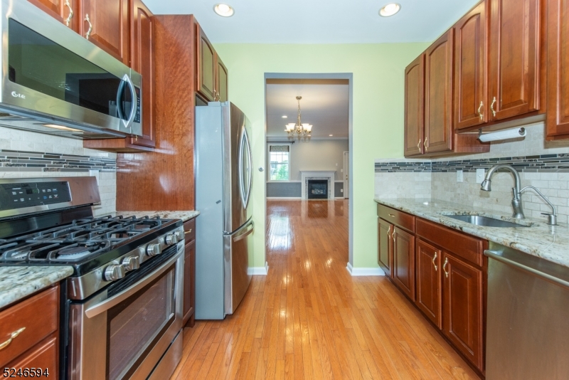 551 Coventry Drive Nutley, NJ 07110 - Photo 7 of 22 a kitchen with stainless steel appliances granite countertop a stove a sink and a microwave