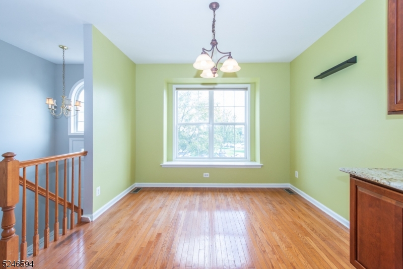 551 Coventry Drive Nutley, NJ 07110 - Photo 10 of 22 a view of an empty room with wooden floor and a window