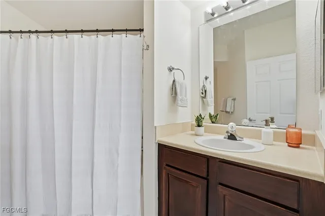 a bathroom with a double vanity sink and mirror