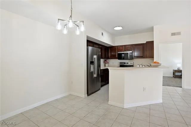a kitchen with granite countertop a sink stove and microwave