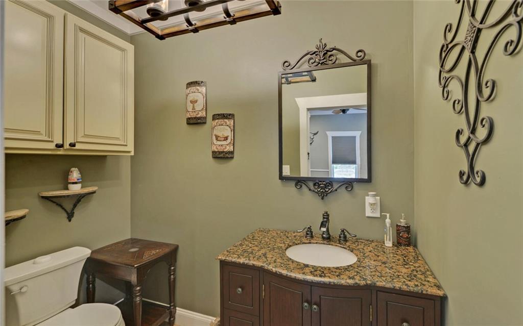 1330 Mc Cannon-Morris Road Colbert, GA 30628 - Photo 29 of 63 a bathroom with a granite countertop sink and a mirror