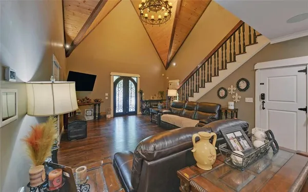 a bedroom with furniture and wooden floor