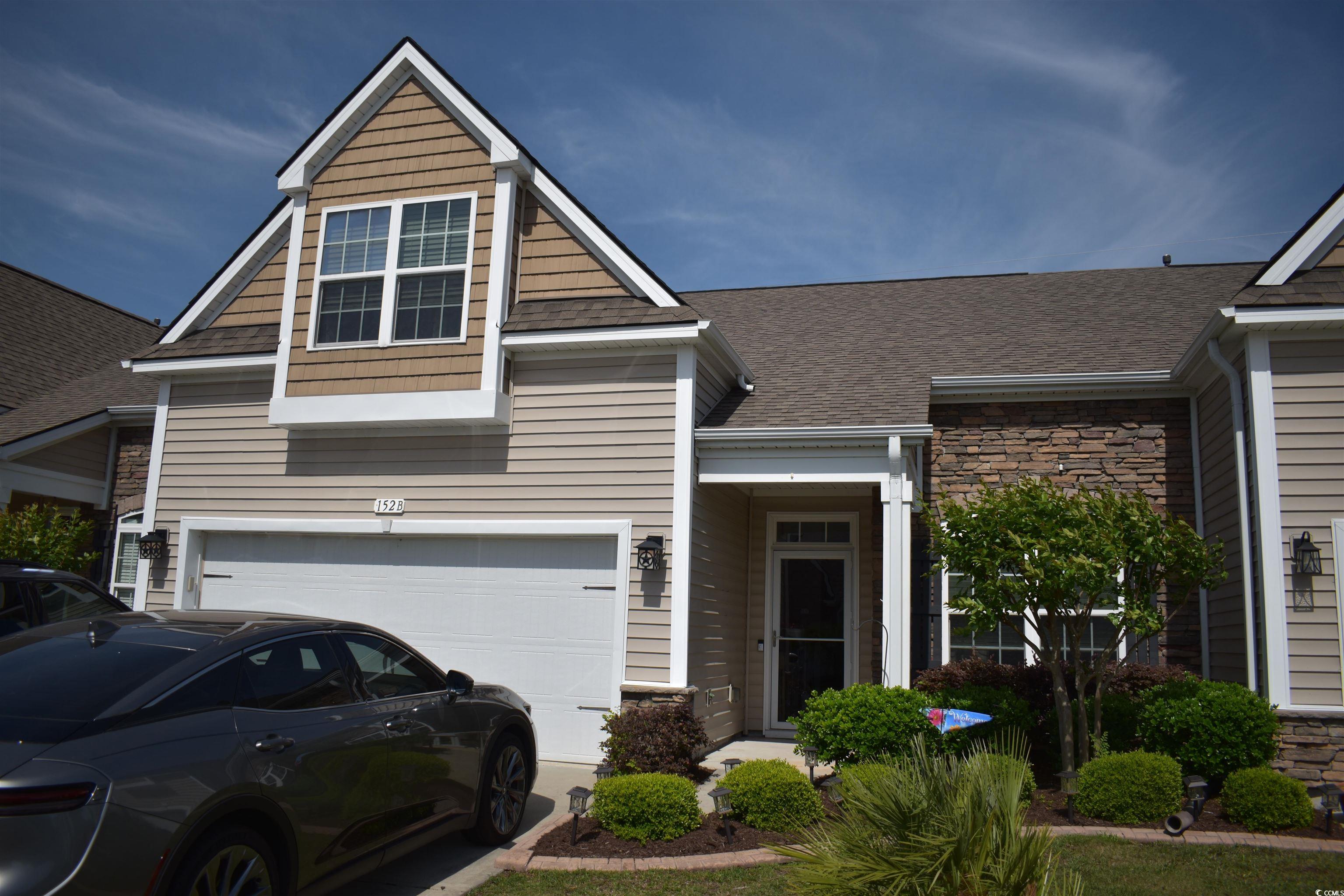 152 Parmelee Drive, Unit B Murrells Inlet, SC 29576 - Photo 1 of 1 Craftsman house with an attached garage, stone sid