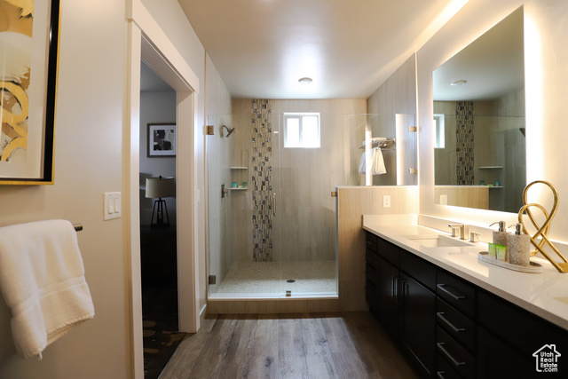 2331 Mesa Road, Unit E3 Moab, UT 84532 - Photo 19 of 71 Full bath with dark wood finished floors, a shower stall, and vanity