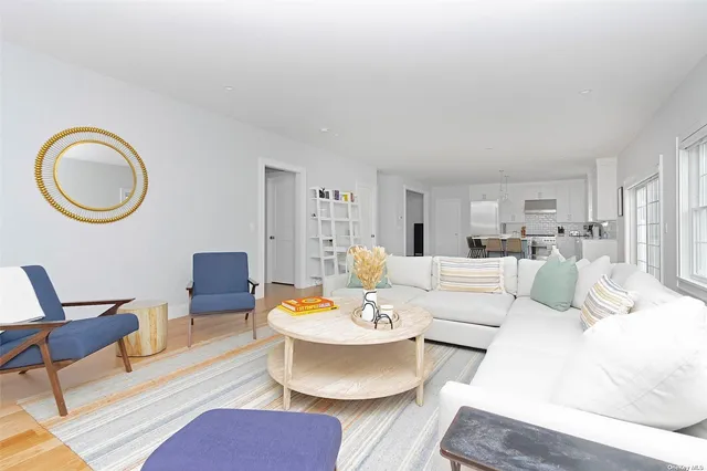 a living room with furniture a dining table and a dining table with kitchen view