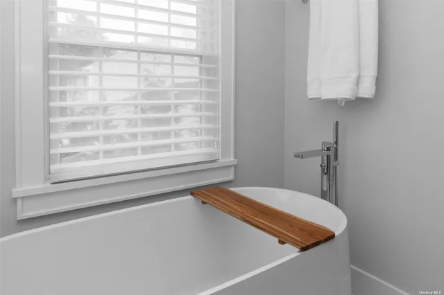 a bathroom with a bathtub and shower