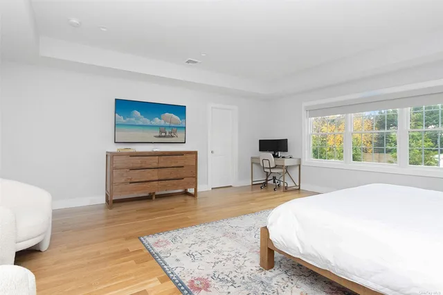 a bed room with a bed and a chair