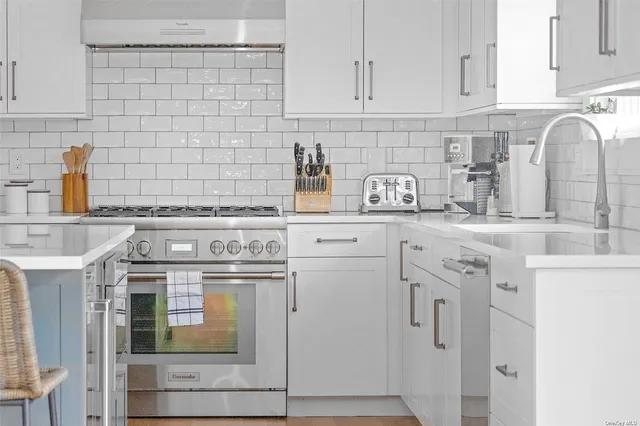 a kitchen with stainless steel appliances granite countertop a sink stove and cabinets