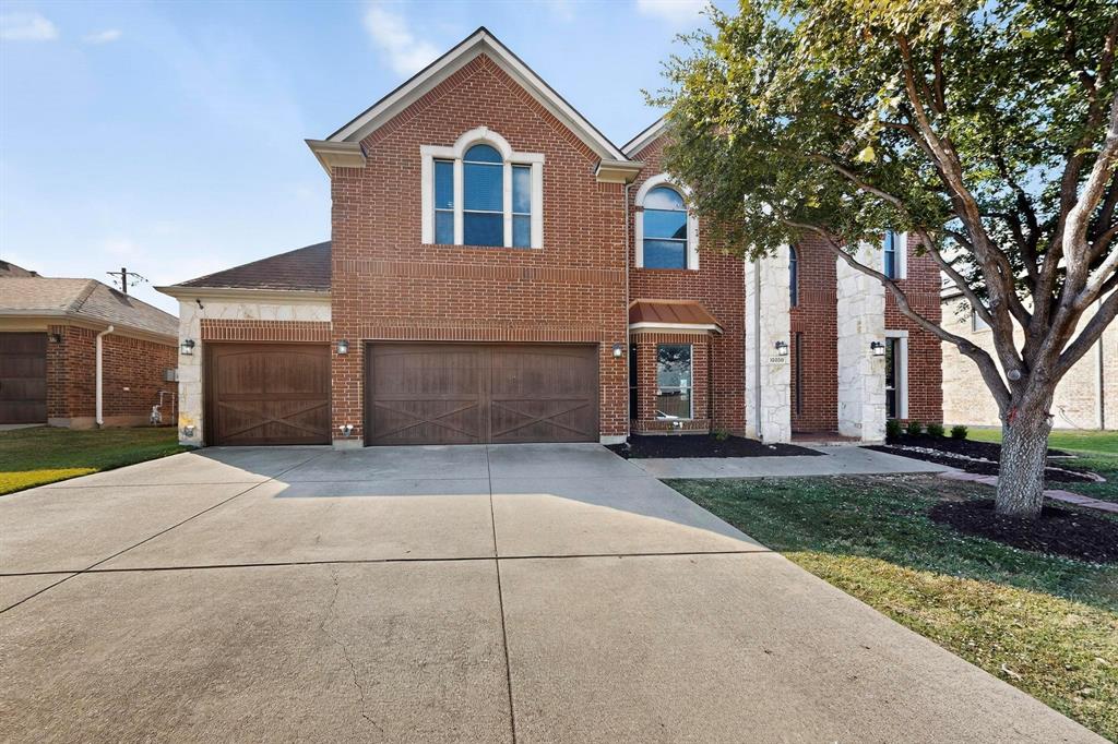 10309 Crowne Pointe Lane Fort Worth, TX 76244 - Photo 2 of 37 a front view of a house with a yard and garage