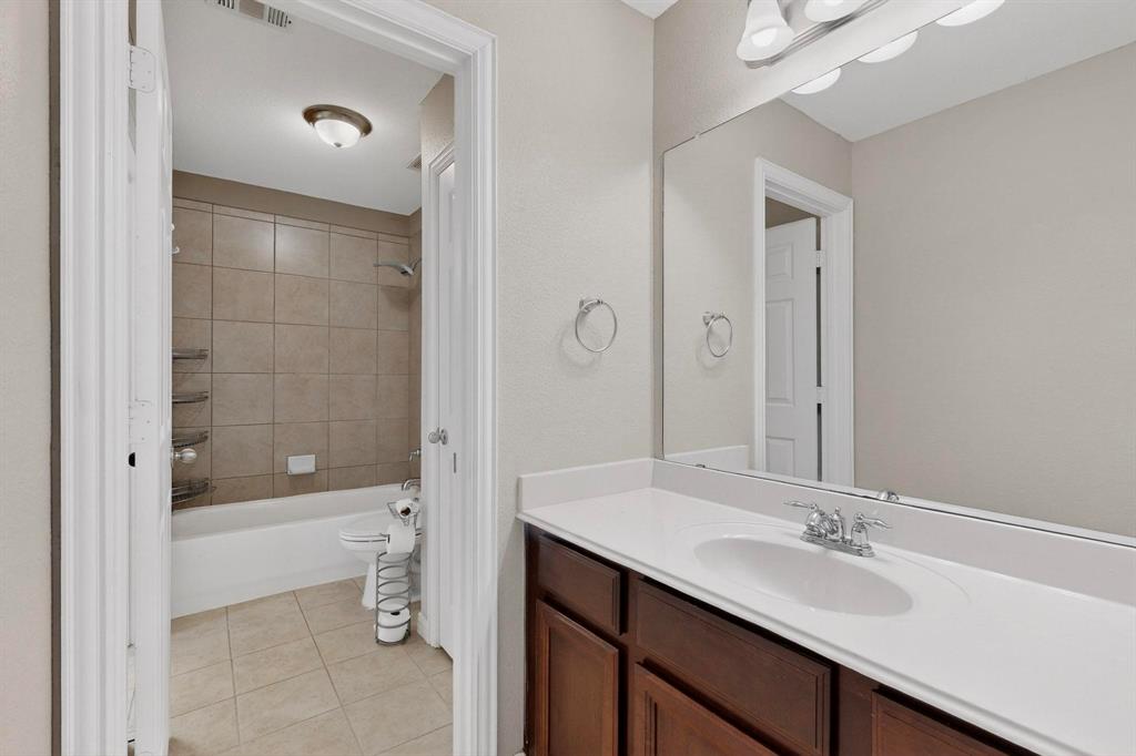 10309 Crowne Pointe Lane Fort Worth, TX 76244 - Photo 23 of 37 a bathroom with a sink a toilet and shower
