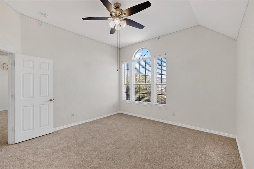 10309 Crowne Pointe Lane Fort Worth, TX 76244 - Photo 24 of 37 an empty room with chandelier fan and windows