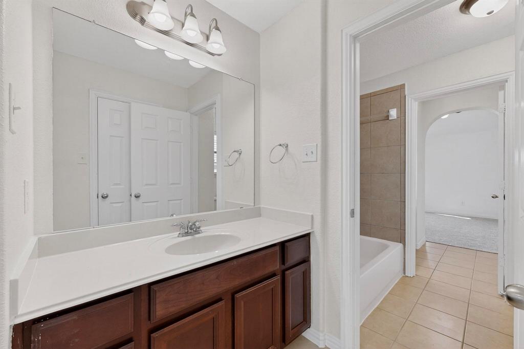 10309 Crowne Pointe Lane Fort Worth, TX 76244 - Photo 27 of 37 a bathroom with a sink a vanity and a mirror