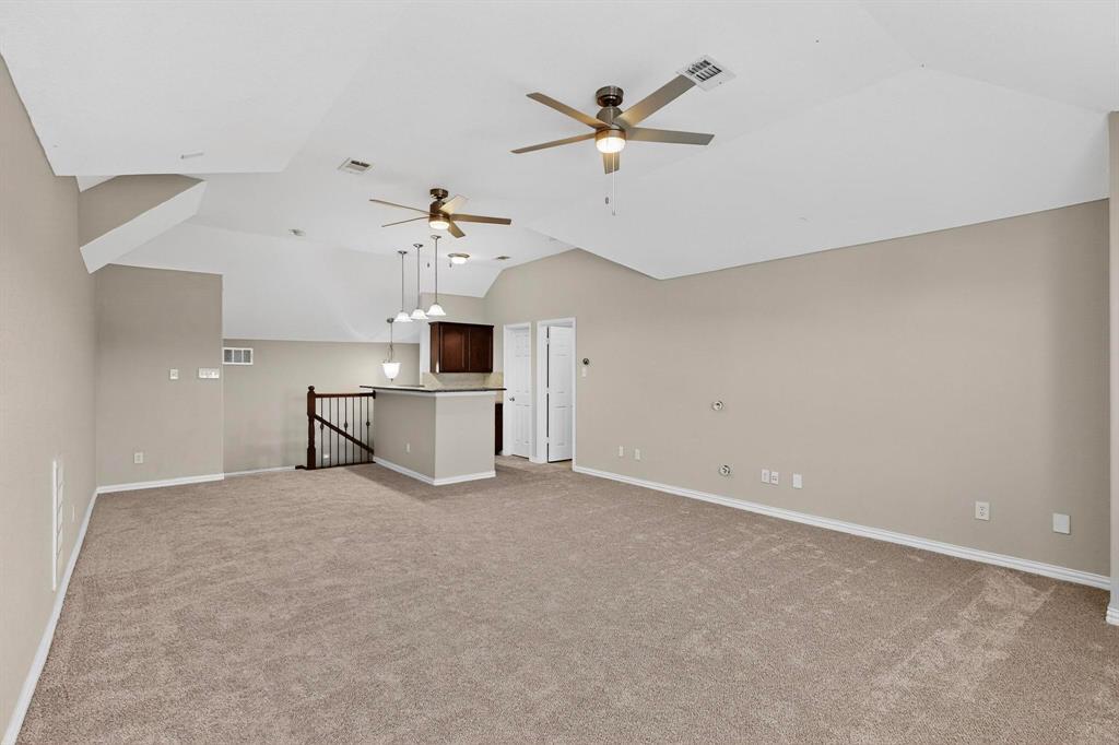 10309 Crowne Pointe Lane Fort Worth, TX 76244 - Photo 30 of 37 an empty room with chandelier fan and windows