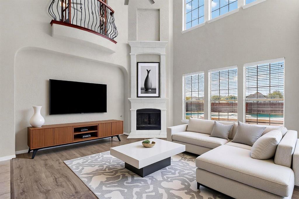 10309 Crowne Pointe Lane Fort Worth, TX 76244 - Photo 7 of 37 a living room with furniture flat screen tv and a fireplace