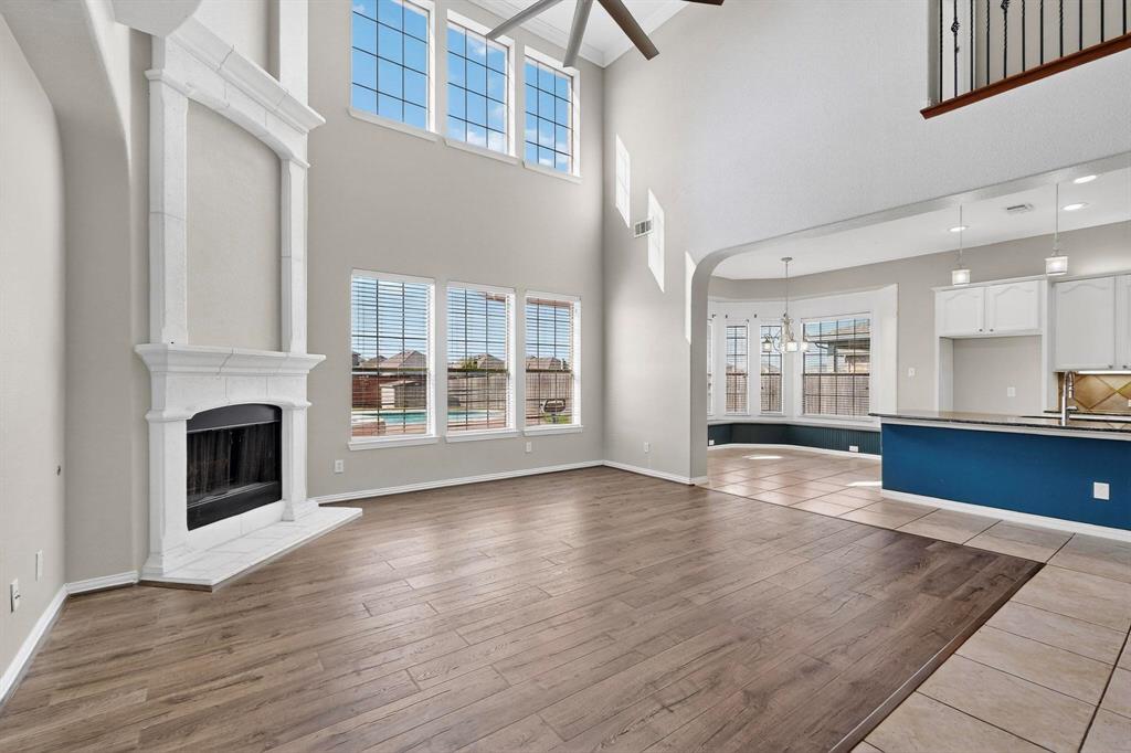 10309 Crowne Pointe Lane Fort Worth, TX 76244 - Photo 9 of 37 a view of an empty room with wooden floor and a kitchen