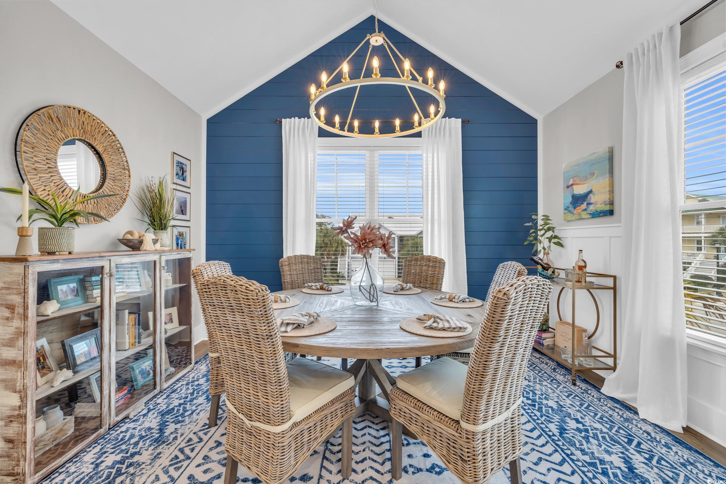 22 Trigger Fish Lane Murrells Inlet, SC 29576 - Photo 13 of 39 Dining area featuring an inviting chandelier, a healthy amount of sunlight, wooden walls, and vaulted ceiling