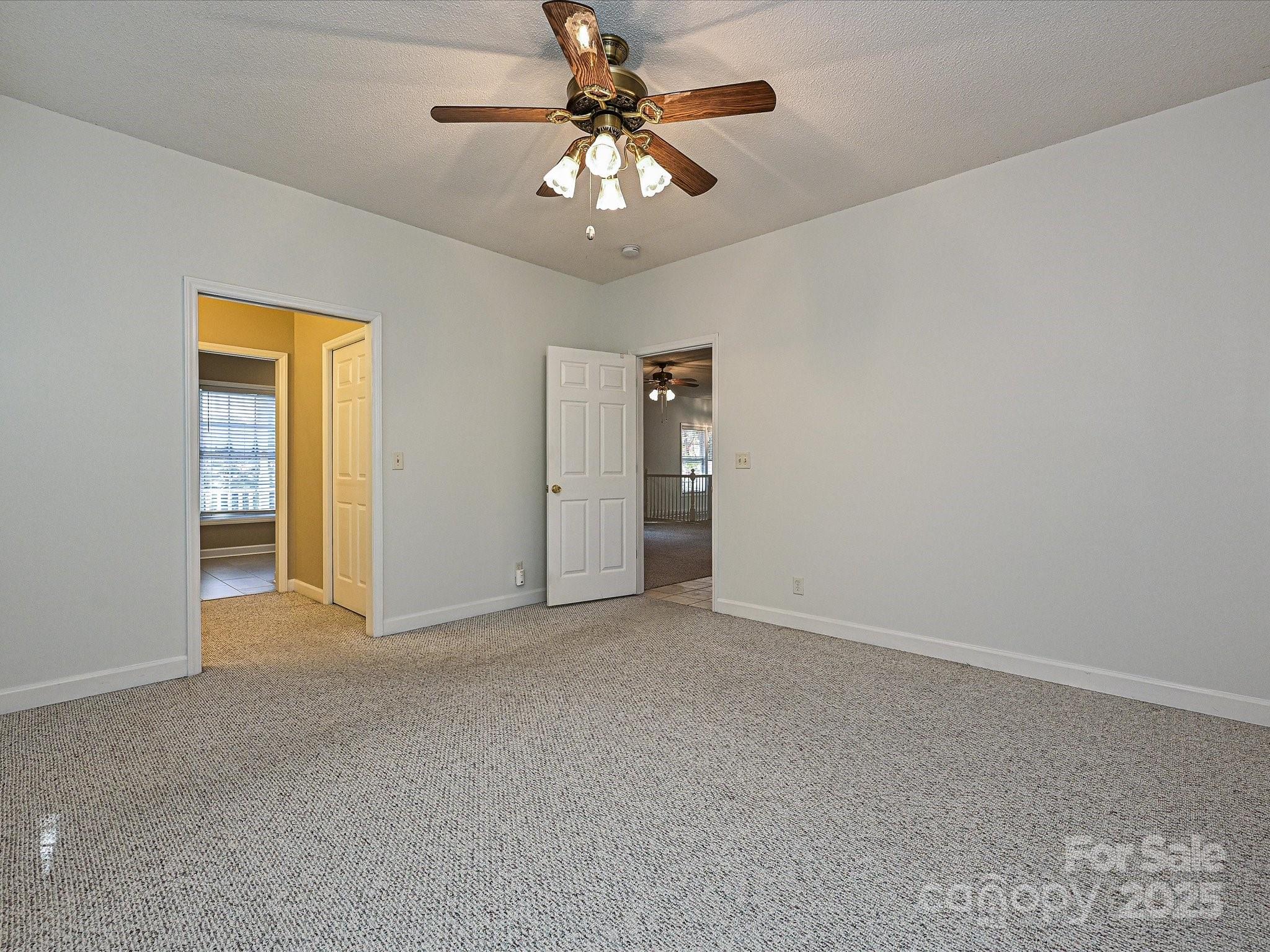 25040 Timberlake Drive Tega Cay, SC 29708 - Photo 23 of 40 a view of empty room with a ceiling fan