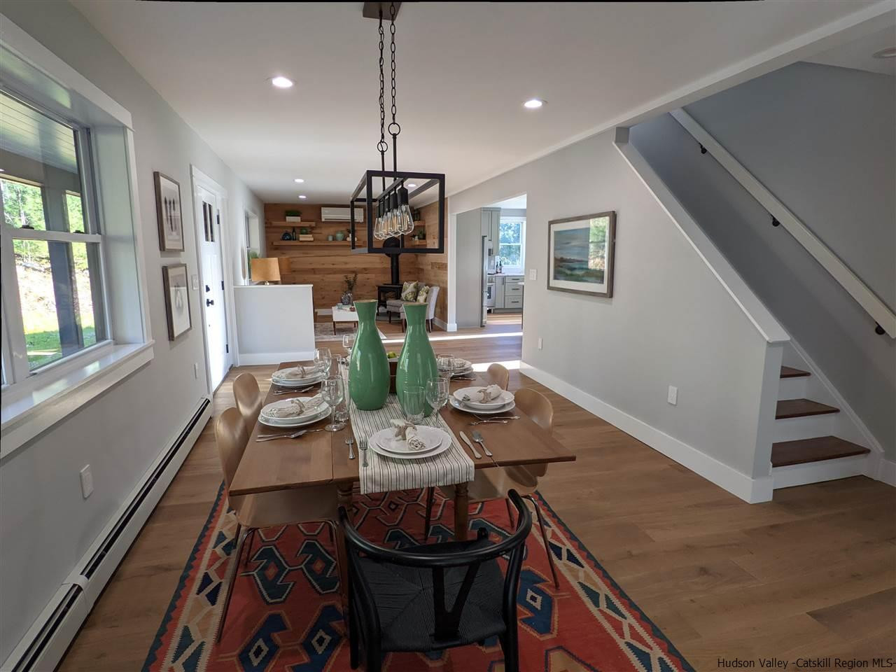 238 Chestnut Hill Road Stone Ridge, NY 12484 - Photo 13 of 35 a view of a dining room with furniture a rug and wooden floor