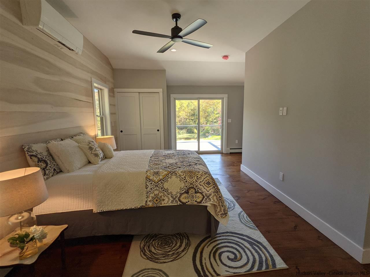 238 Chestnut Hill Road Stone Ridge, NY 12484 - Photo 20 of 35 a bedroom with a bed and a chandelier