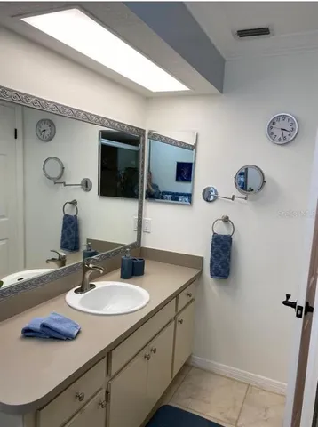 a bathroom with a sink double vanity and a mirror