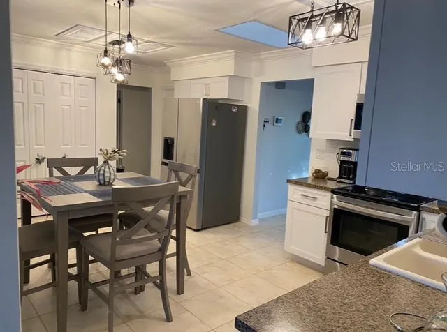 a kitchen with a table and chairs in it