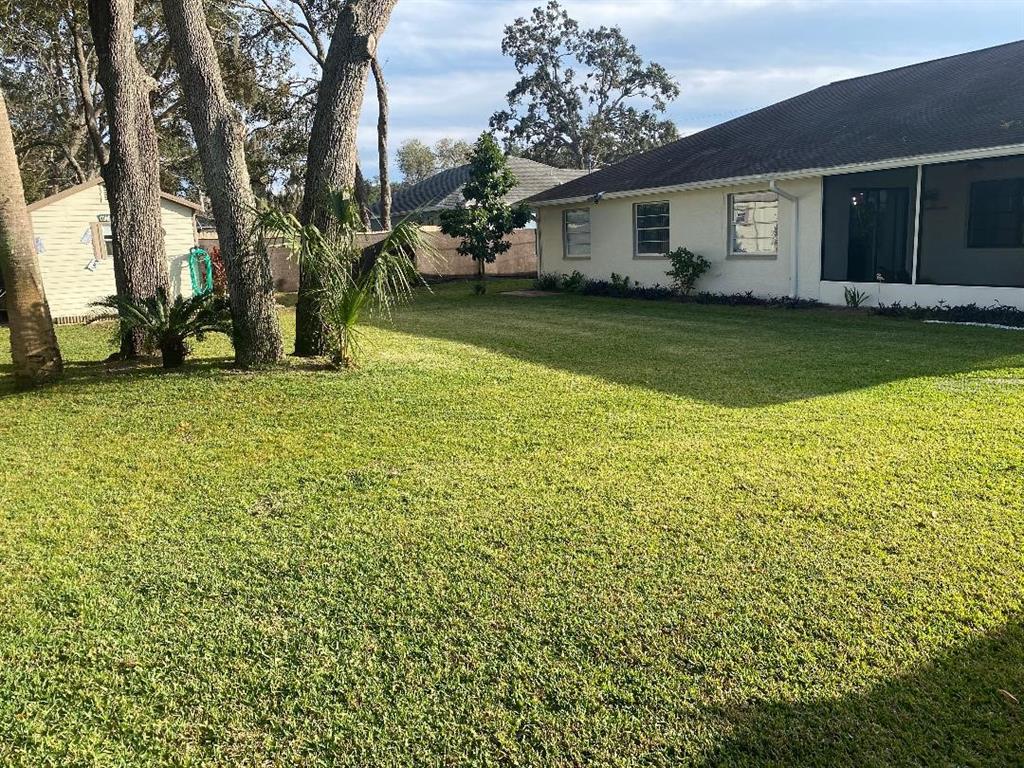 8437 Gibralter Street Spring Hill, FL 34608 - Photo 26 of 30 a view of a house with a yard