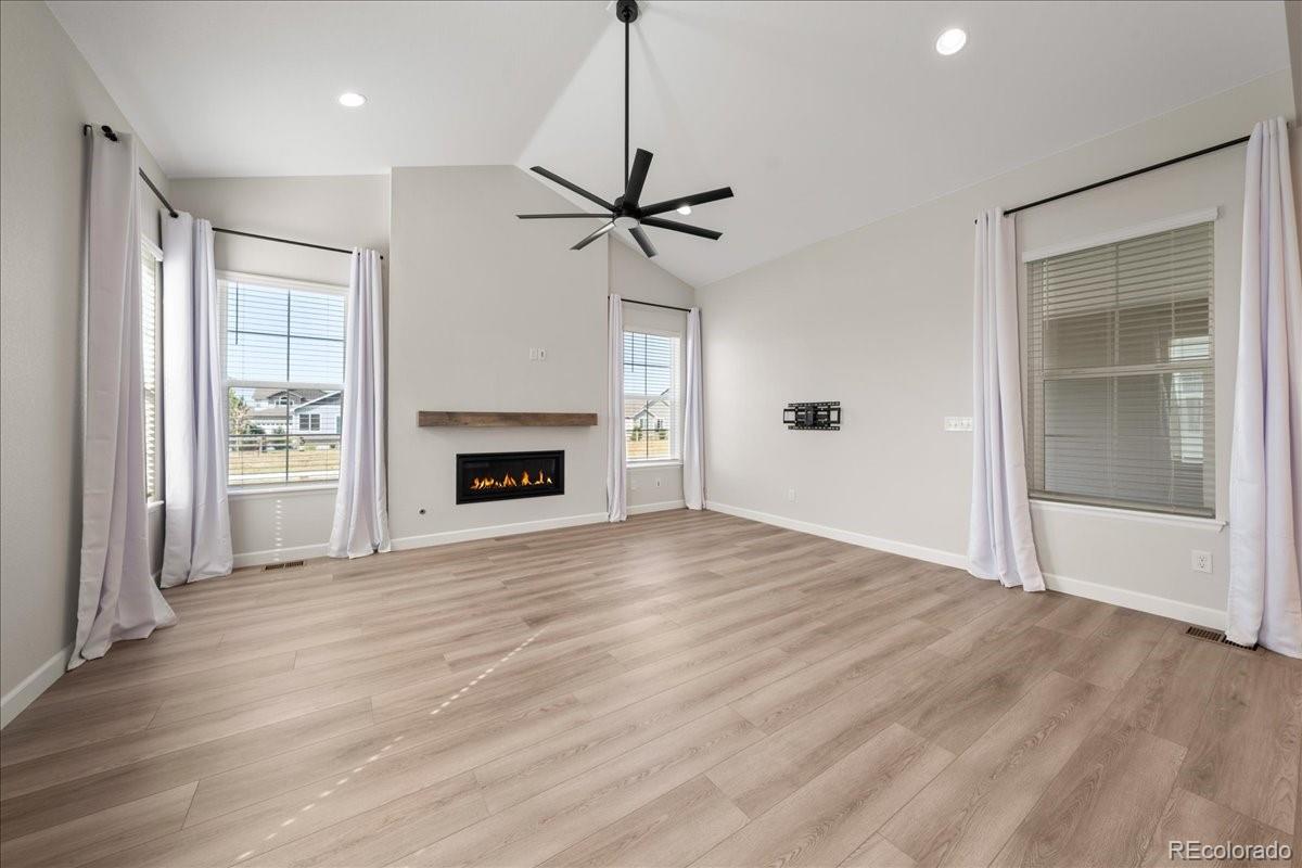 1335 Alyssa Drive Timnath, CO 80547 - Photo 11 of 50 a view of an empty room with a fireplace and a window