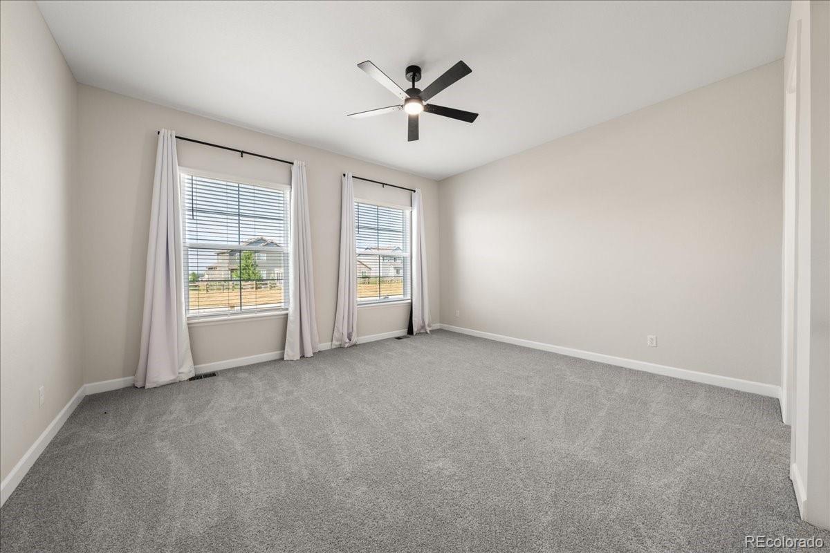 1335 Alyssa Drive Timnath, CO 80547 - Photo 15 of 50 an empty room with windows and ceiling fan