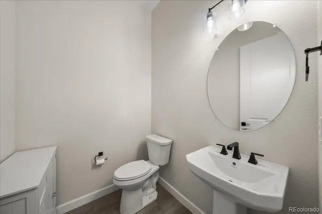 an empty room with chandelier fan and windows