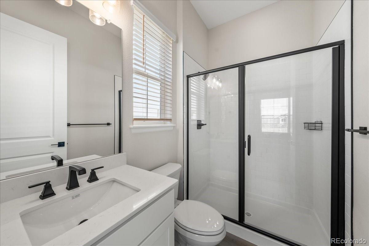 1335 Alyssa Drive Timnath, CO 80547 - Photo 18 of 50 a bathroom with a sink toilet a mirror and shower