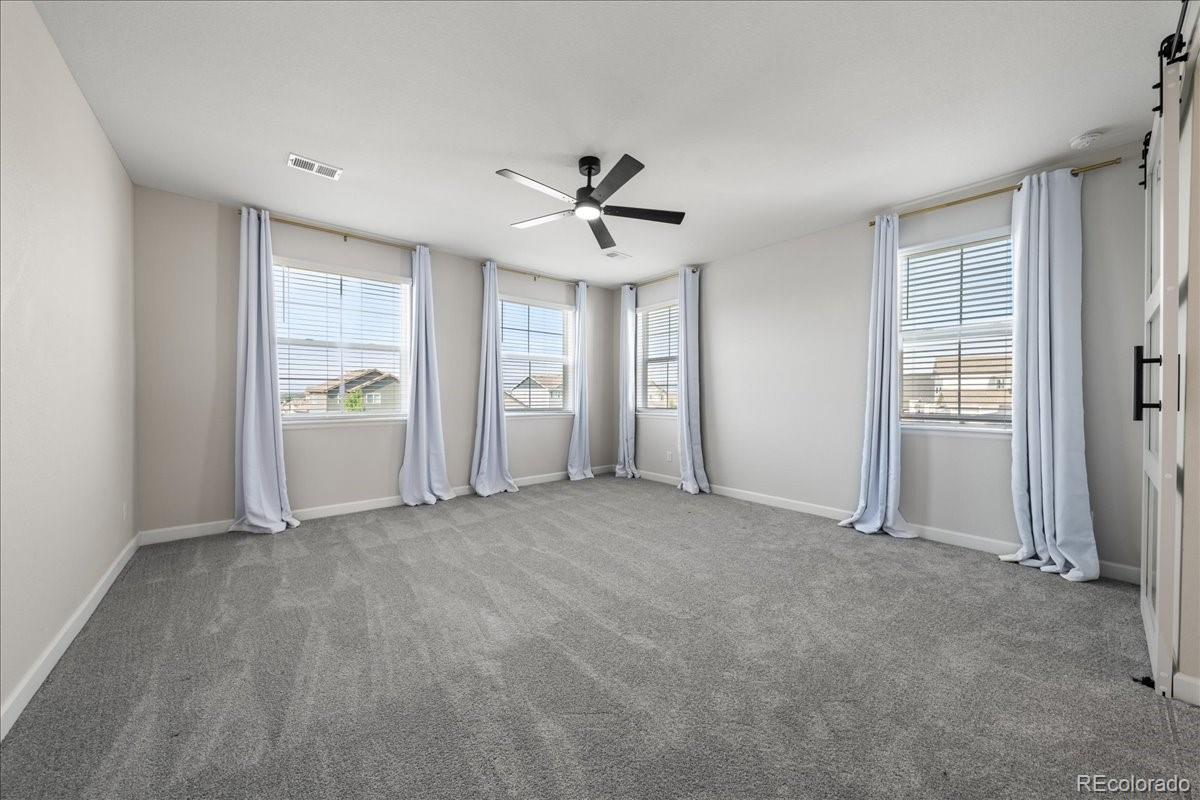 1335 Alyssa Drive Timnath, CO 80547 - Photo 19 of 50 an empty room with windows and cabinet