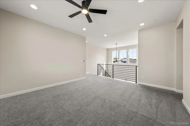 an empty room with windows and cabinet