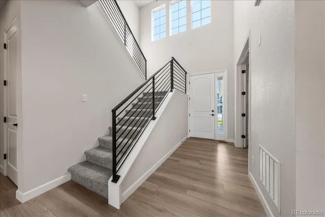 a view of entryway and hall with wooden floor