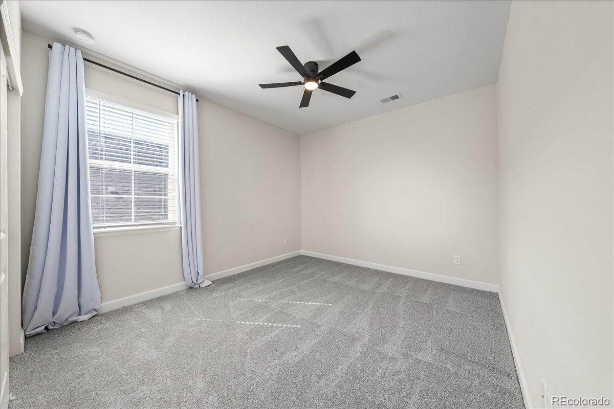 1335 Alyssa Drive Timnath, CO 80547 - Photo 33 of 50 an empty room with windows and fan