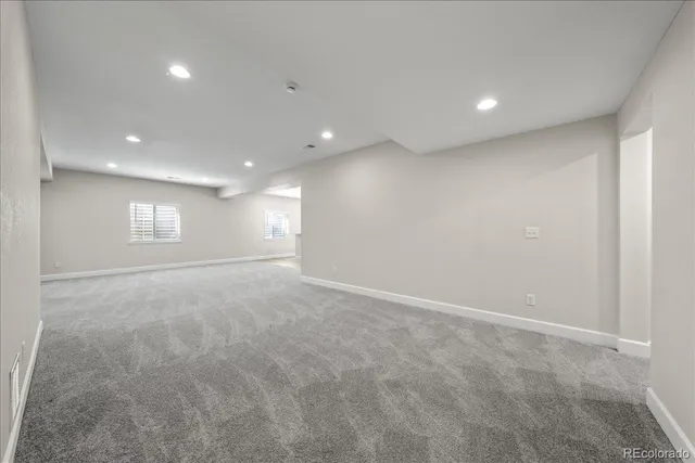 an empty room with a empty space and windows