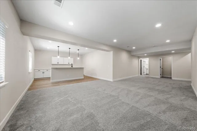 a view of a room with wooden floor and windows