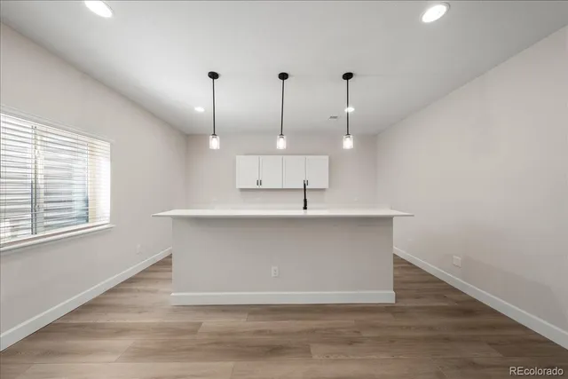 a kitchen with sink stove and cabinets