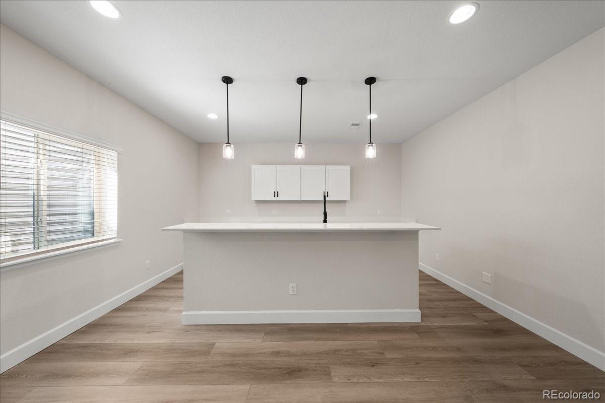 1335 Alyssa Drive Timnath, CO 80547 - Photo 41 of 50 a view of a room with wooden floor and windows