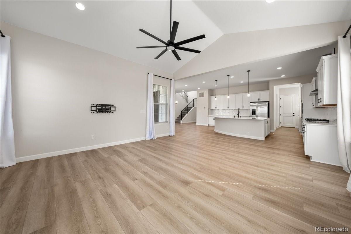 1335 Alyssa Drive Timnath, CO 80547 - Photo 9 of 50 a view of a living room hardwood floor and a ceiling fan