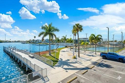 337 Rex Place, Unit A Madeira Beach, FL 33708 - Photo 38 of 48 a view of a swimming pool with a patio and a garden