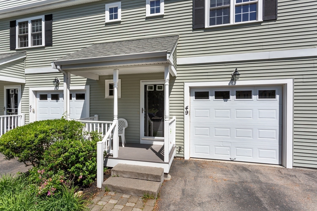 49 Beaver Street, Unit 49 Franklin, MA 02038 - Photo 33 of 46 a view of a house with more windows and a small yard