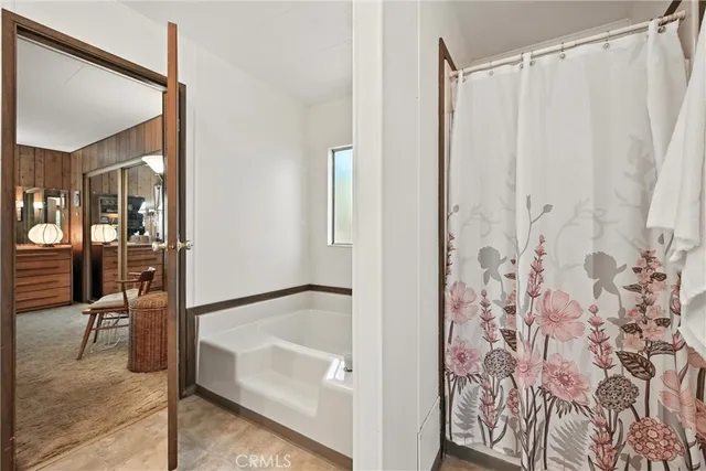 a bathroom with a bathtub and shower