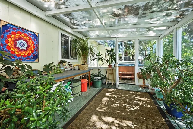a room with lots of flowers and a chandelier